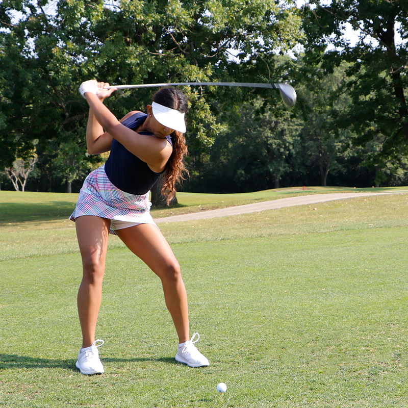 golfer taking swing on course