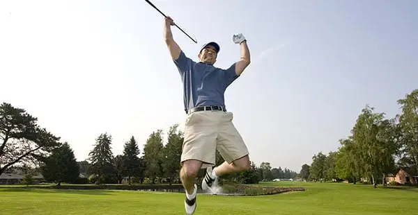 Golfer jumping for joy on the course