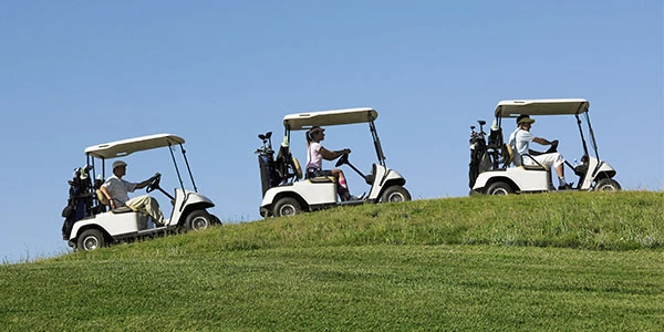 Carts in line going up a hill 